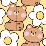 a brown teddy bear sitting next to a white flower