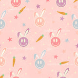 a repeating pattern of smiling bunny faces and carrots against a pink background.