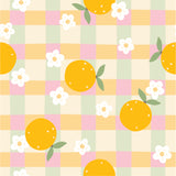a pattern of oranges and flowers on a checkered tablecloth