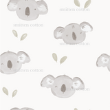 a watercolor drawing of a koala and leaves