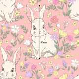 a pattern of cartoon rabbits surrounded by colorful flowers and leaves on a pink background.