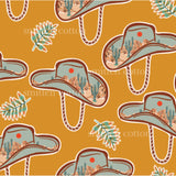 a pattern of cowboy hats and cactus plants on an orange background