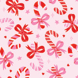 a pink background with red bows and stars