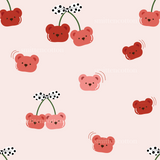 a pattern of cherries and bears on a pink background