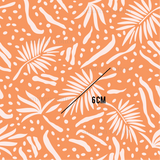 an orange and white pattern with white leaves and dots
