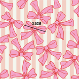 a pattern of pink bows on a striped background