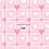a pink and white pattern with hearts on it