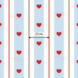 a repeating pattern of red hearts on a blue background, with a ruler indicating the size of the pattern.