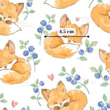 a repeating pattern of cartoon-style illustrations of sleeping foxes, along with blueberries and leaves. The foxes are depicted in various poses, and the background is predominantly white. There is also a measurement scale visible in the image, indicating the size of the foxes and the blueberries.