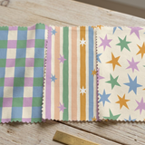 three fabric swatches with different patterns, including a checkered pattern, stripes, and stars.