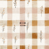 a repeating pattern of small floral designs on a checkered background.