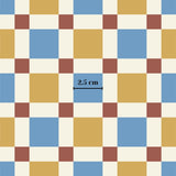 The image is a square pattern with a grid of squares in various colors, including blue, yellow, red, and white. The image is approximately 2.5 centimeters in size.