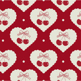a repeating pattern of white hearts with red cherries and bows on a red background.