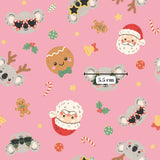 a repeating pattern of various Christmas-themed characters and objects, including Santa Claus, koalas, gingerbread cookies, and other festive elements, all set against a pink background.