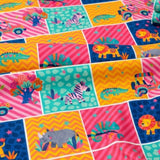 The image is a vibrant and playful collage of various animal illustrations, including a zebra, lion, crocodile, and rhinoceros, all set against a backdrop of colorful geometric patterns.