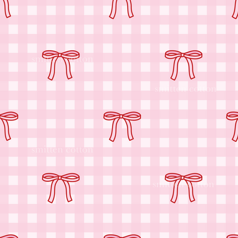 a pattern of red bows on a pink background