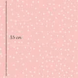 a pink background with white polka dots