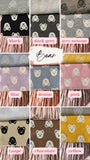 The image is a collage of various fabric swatches featuring different patterns and colors, including black, dark grey, grey melange, black, pink, denim, pink, taupe, chocolate, and yellow.