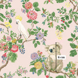 The image is a vibrant and colorful illustration featuring a koala bear and a parrot perched on branches adorned with flowers and leaves. The koala bear is positioned on the right side of the image, while the parrot is located on the left. The background is a soft pink color, providing a pleasant contrast to the vivid colors of the animals and flowers. The image is a detailed and lively depiction of the natural world, showcasing the beauty and diversity of wildlife.