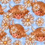 a repeating pattern of cartoon cow heads with flowers on a blue background.