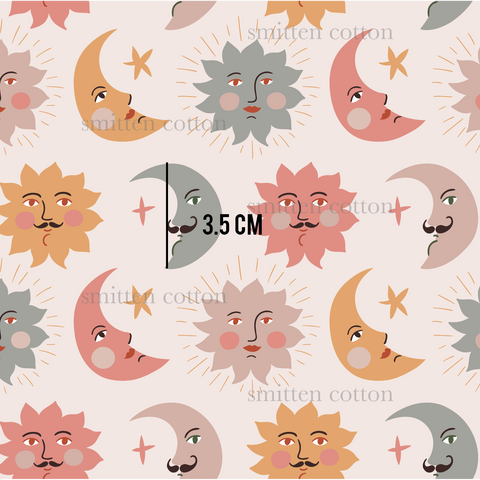 a pattern of sun and moon faces on a pink background