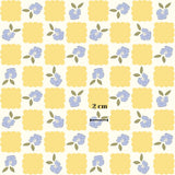 a repeating pattern of yellow squares and blue flowers on a white background.