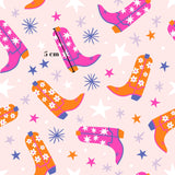 a repeating pattern of colorful cowboy boots and stars on a pink background.