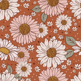a repeating pattern of large white and pink flowers with brown centers, surrounded by small white flowers and leaves against a brown background with scattered stars.