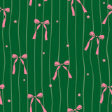 a repeating pattern of pink bows and stars against a green background with vertical lines.