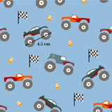 a pattern of various monster trucks and checkered flags on a blue background.