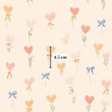 a repeating pattern of heart-shaped balloons with bows, and there is a measurement scale in the center indicating the size of the balloons.