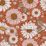 a repeating pattern of large pink and white flowers with green leaves against a brown background.
