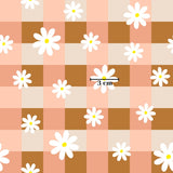 a repeating pattern of white daisies against a background of pink and brown squares.