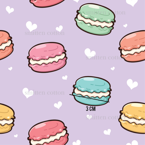 a bunch of different colored donuts on a purple background