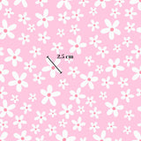 a repeating pattern of white flowers against a pink background. The pattern is composed of numerous small white flowers, creating a visually appealing and harmonious design. The image is approximately 2.5 cm in size.