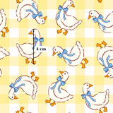 a repeating pattern of cartoon-style white ducks with blue bows on their necks, arranged in a grid-like pattern on a yellow background.