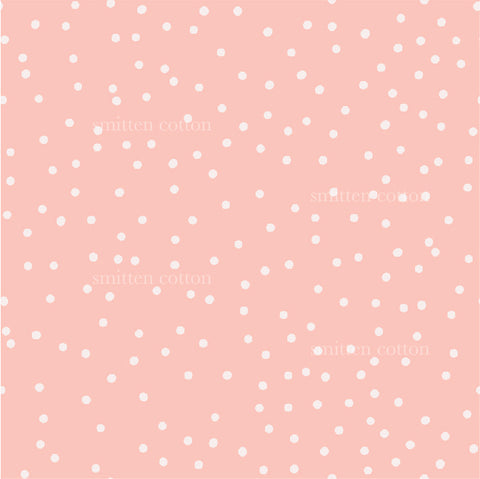 a pink background with white polka dots