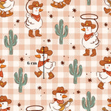 a repeating pattern of cartoon ducks wearing cowboy hats and bandanas, along with cacti and stars, creating a whimsical and playful design.