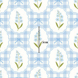 The image is a repeating pattern of blue and white checkered frames, each containing a blue flower and a blue ribbon. The pattern is centered, and there is a 5 cm measurement visible in the image.