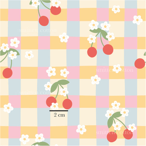 a pattern with cherries on a checkered tablecloth