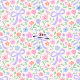 a repeating pattern of pink, blue, and purple flowers with purple bows, along with green leaves and stems. The pattern is composed of various flower types and sizes, creating a visually appealing and colorful design.