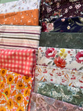 a variety of colorful fabric swatches, each with unique patterns and designs, arranged in a visually appealing manner.