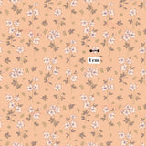 a repeating pattern of small white flowers with green leaves against a peach-colored background.