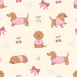 a repeating pattern of cartoon-style dachshunds wearing pink sweaters, with cherries and bows scattered throughout the background.