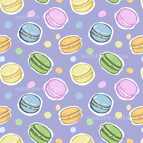 a repeating pattern of colorful macarons against a purple background.