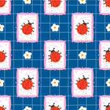 a repeating pattern of pink and white pillows with red ladybugs and white flowers on a blue background.
