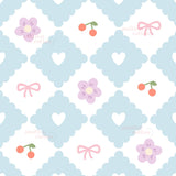 a repeating pattern of blue diamond shapes with pink flowers and cherries, along with pink bows and hearts.