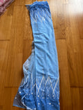 A blue fabric with white star patterns is spread out on a wooden floor.