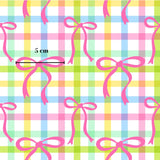 a repeating pattern of pink bows against a colorful, checkered background. The bows are arranged in a grid-like pattern, creating a visually appealing and playful design.