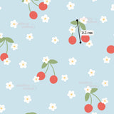 The image is a repeating pattern of red cherries and white flowers against a light blue background.